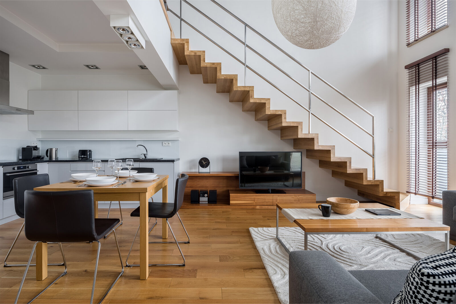 Spacious open concept living room with a large area rug
