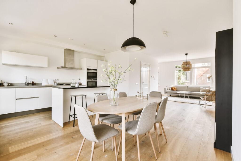 Modern kitchen and living space featuring laminate flooring