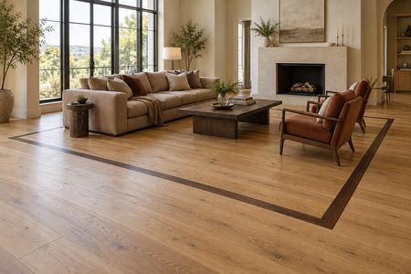 Modern open-concept living room with hardwood flooring and a dark wood border | Carpetland USA